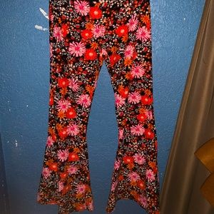 Leggings/bell bottoms. Decorated in pink and orange flowers.From halloween store